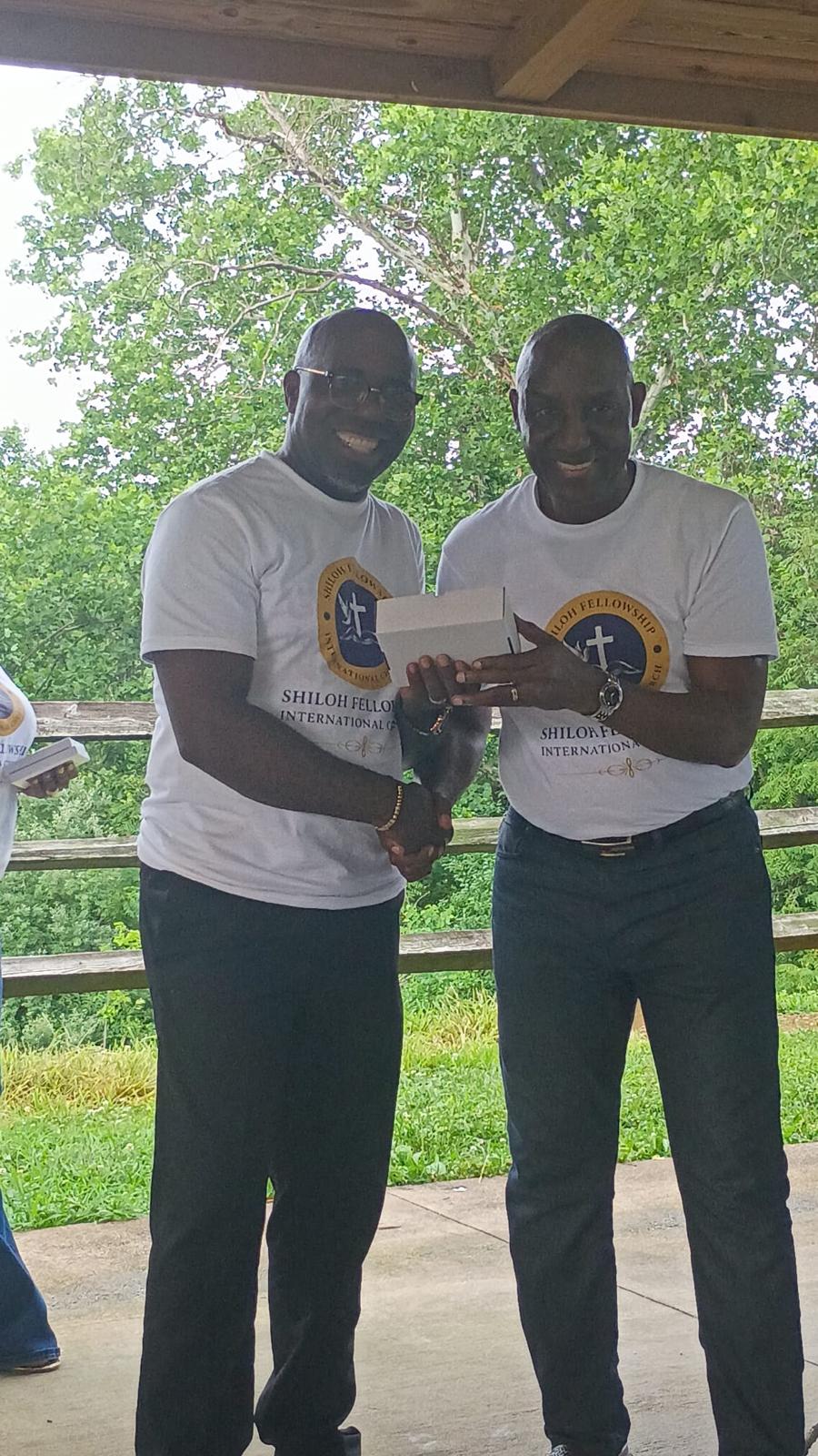 Two Shiloh Fellowship members greeting each other outdoors